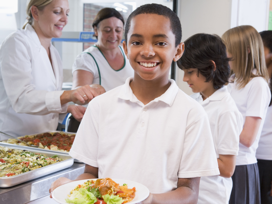 School child with healthy school lunch